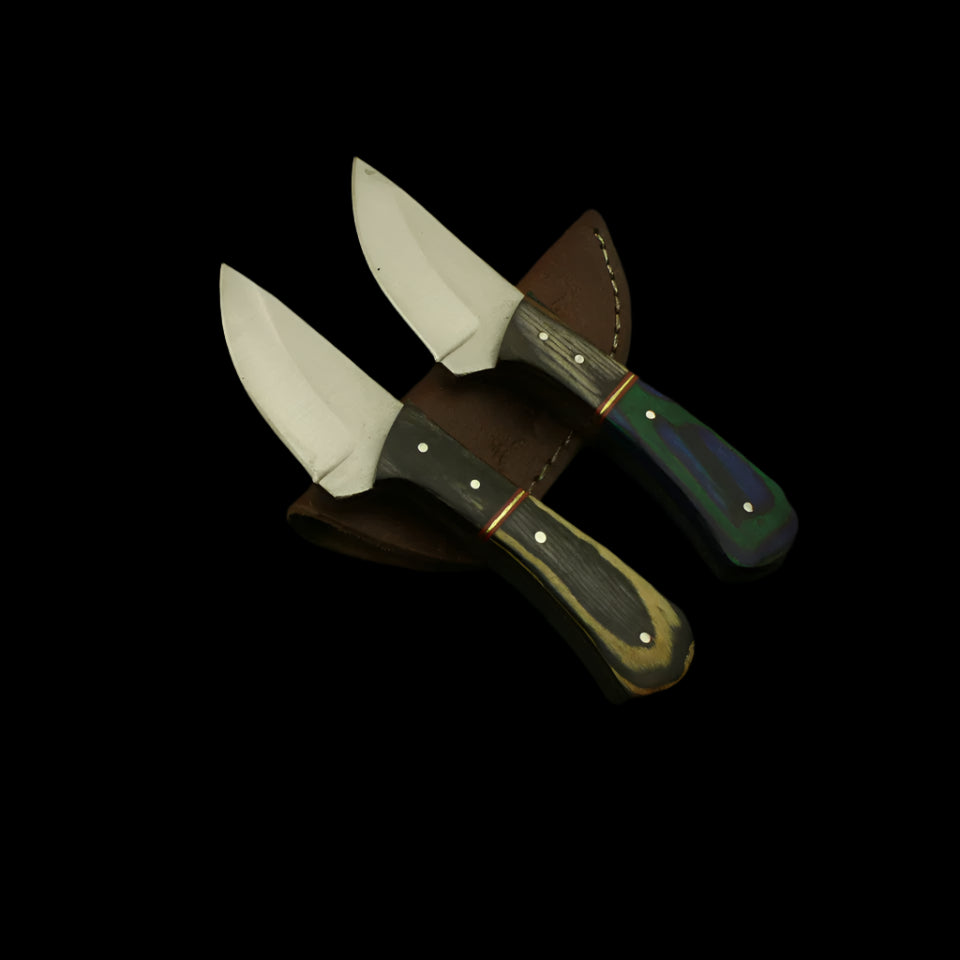 Two knives with leather sheaths on a dark surface