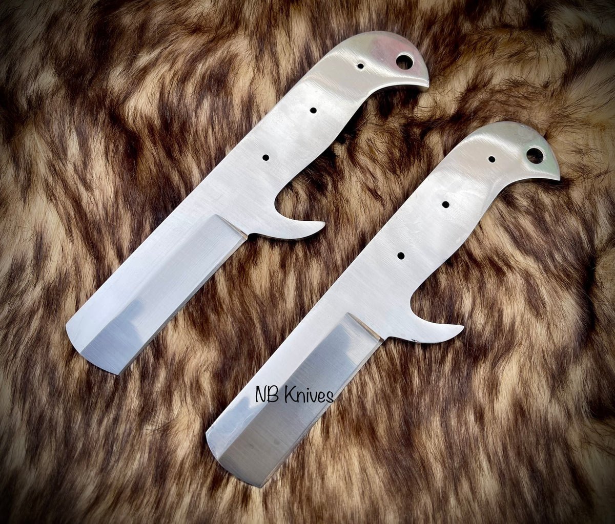 Two blank blades with leather sheaths on a furry surface, marked with NB Knives brand.