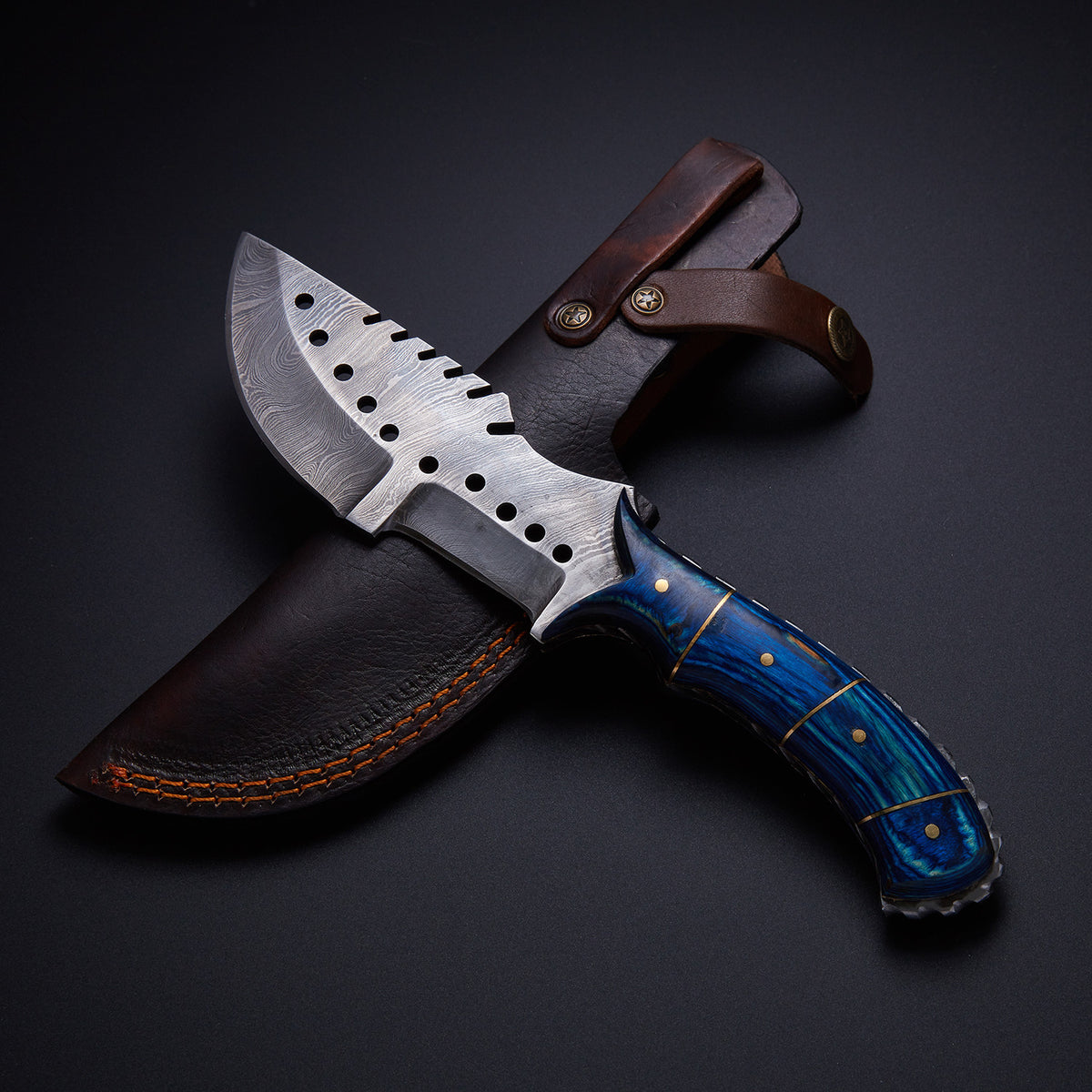 A custom handmade Damascus steel tracker knife with a blue hardwood handle With Leather sheath