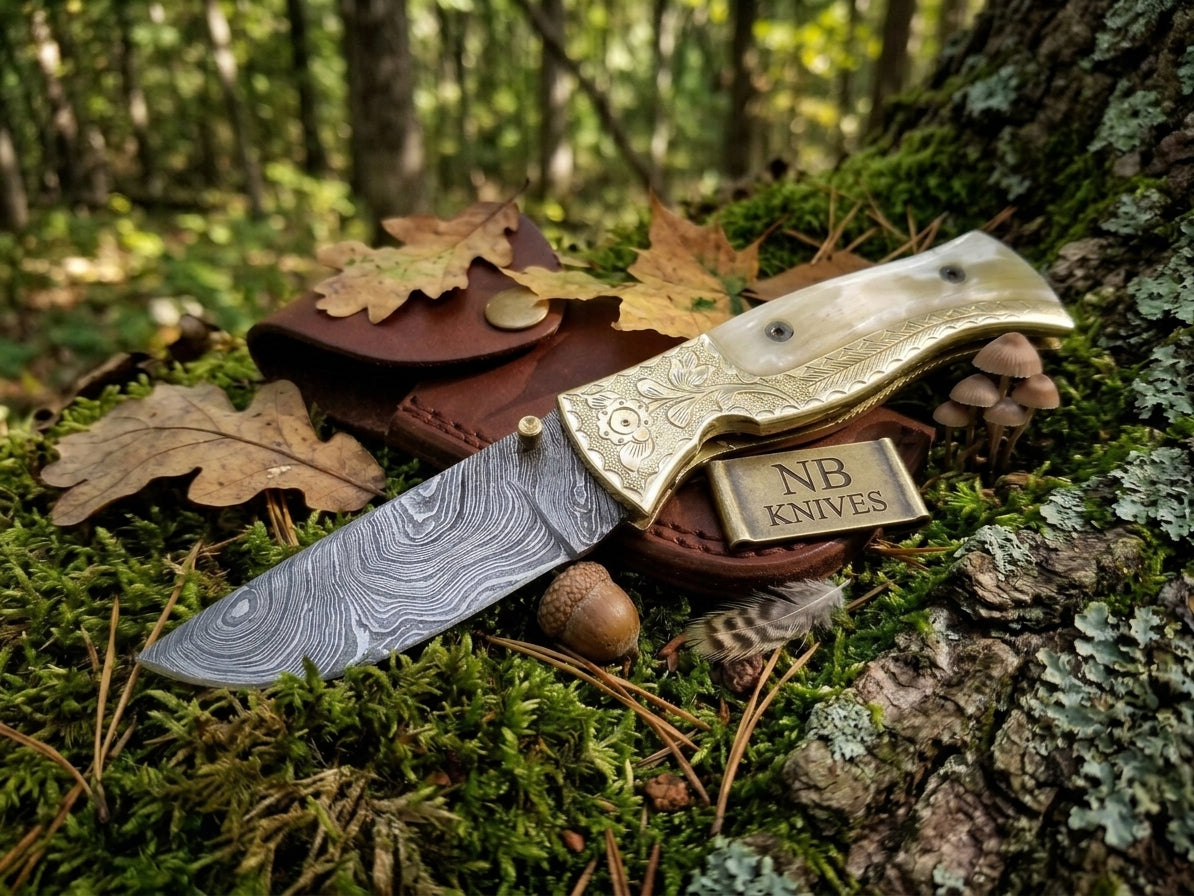 Cow bone handle Damascus folding knife with engraved bolster and leather sheath