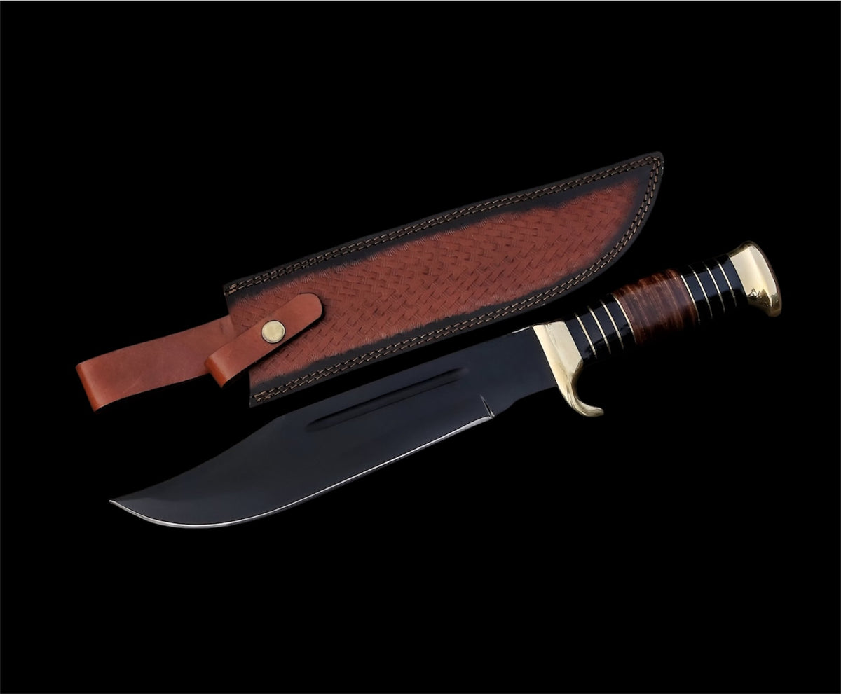 A black-handled hunting knife with a powder-coated blade and brass guards, accompanied by a brown leather sheath.