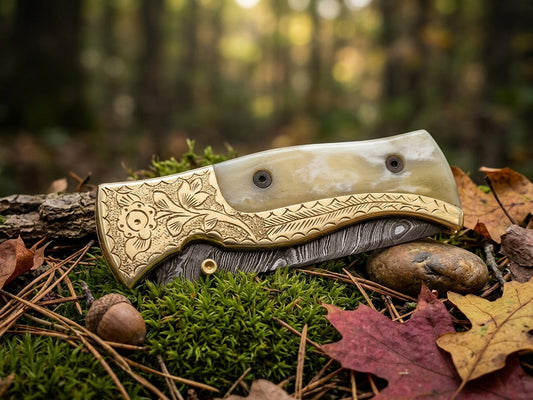 Damascus steel folding knife with engraved bolster and cow bone handle