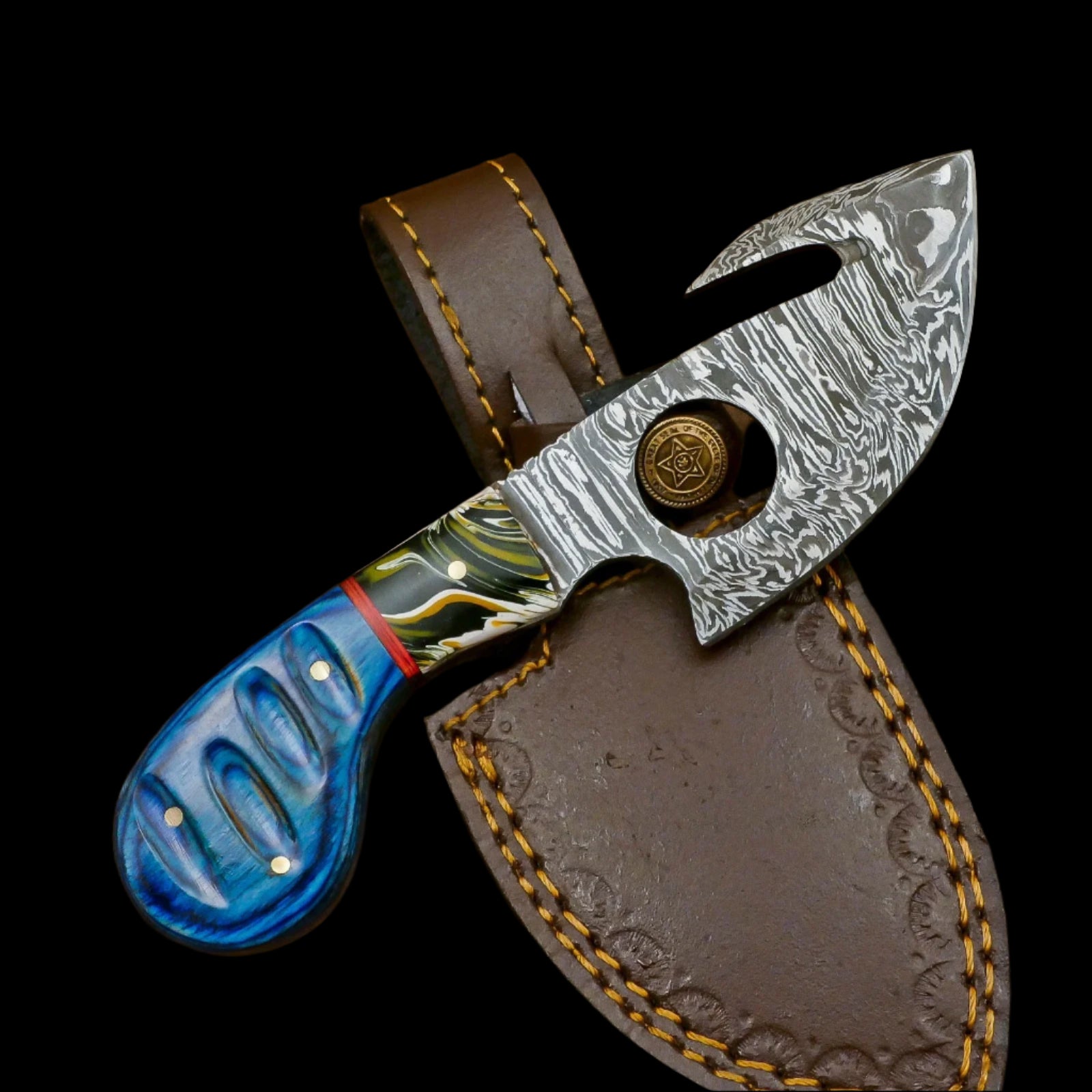 Decorative knife with a blue handle and silver blade in a brown leather sheath on a wooden surface