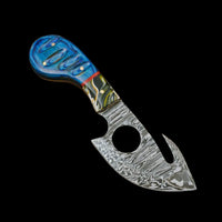 Decorative knife with a blue handle on a wooden surface