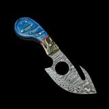 Decorative knife with a blue handle on a wooden surface