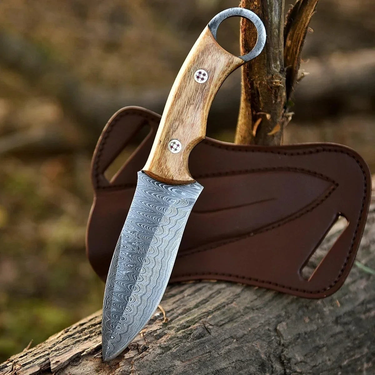 Knife with wooden handle and leather sheath on a wooden surface