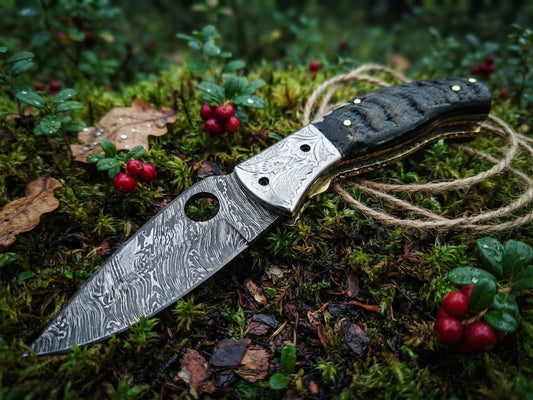 Handmade Damascus steel pocket knife with ram horn handle and leather sheath