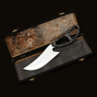 Knife in a wooden box on a natural background