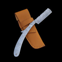 Handmade Damascus steel knife with leather sheath on a wooden surface