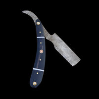 Knife with a blue handle and decorative elements on a wooden background
