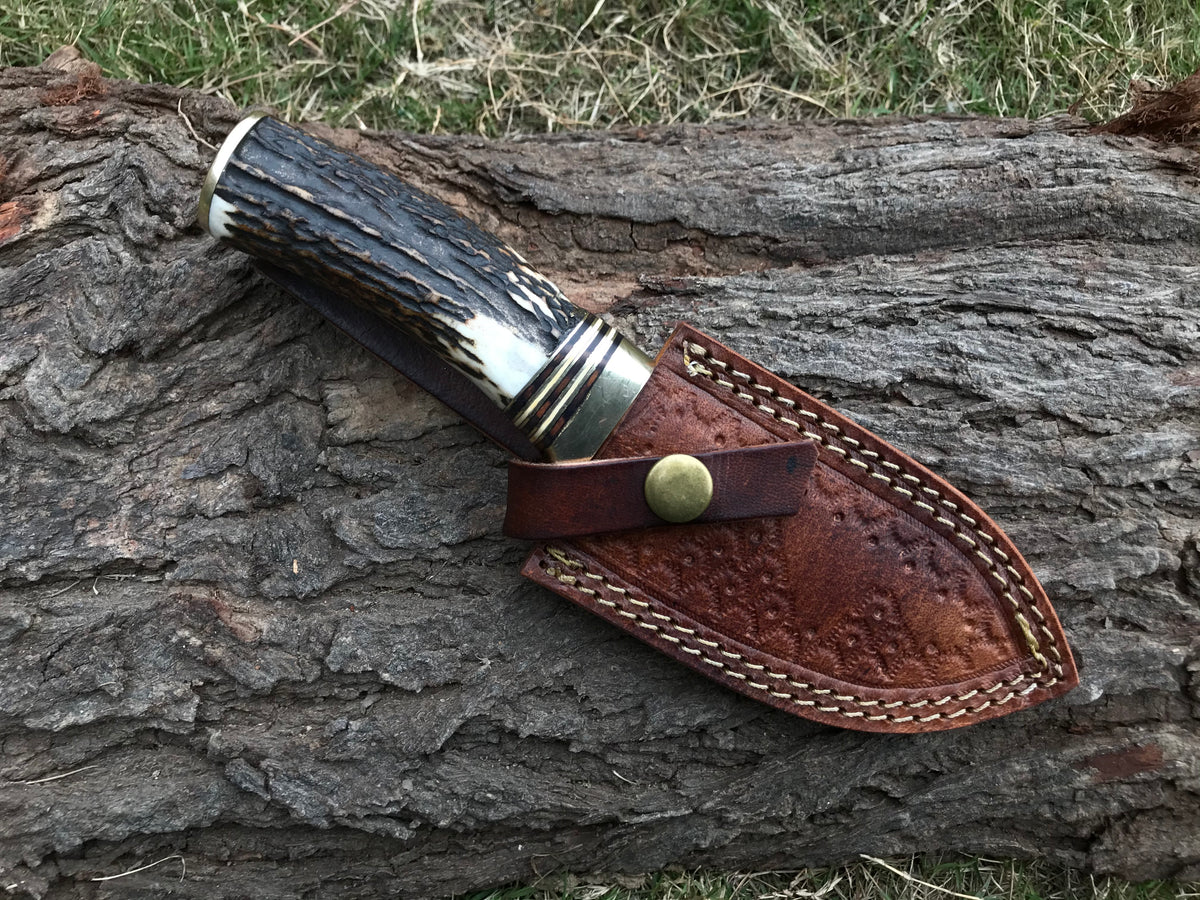 Custom handmade Damascus gut hook knife with genuine Stag Horn handle and leather sheath