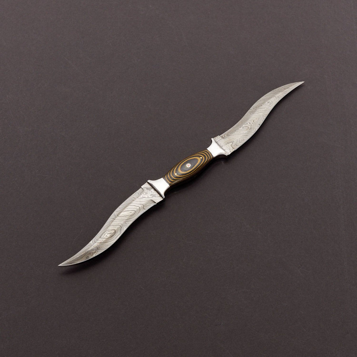 A custom-made Damascus steel hunting knife with a striped pattern blade and a black micarta handle with a mosaic pin, displayed next to its natural leather sheath.