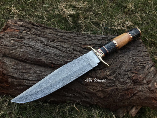 A Damascus steel blade hunting Bowie knife with a wooden handle resting on a wooden stump.
